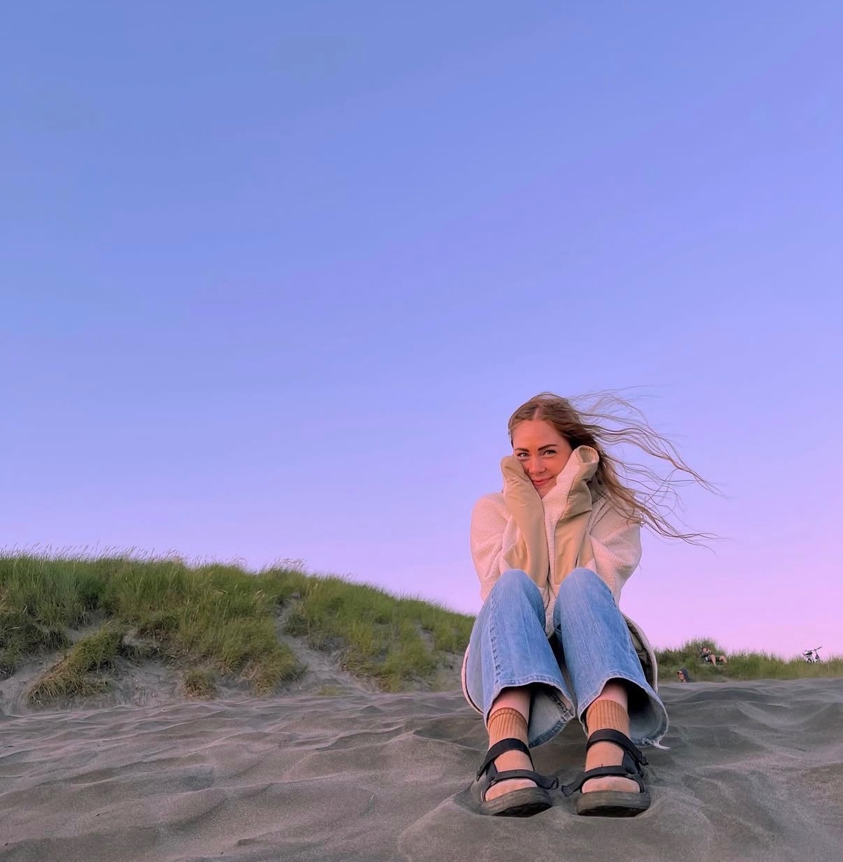 Jaz sitting on a sand dune at sunset